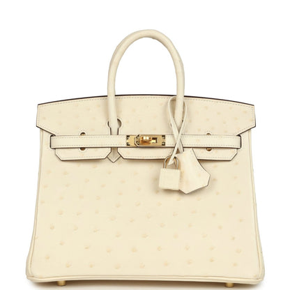Nata ostrich handbag with top handles, front flap, gold-tone lock, and hanging key clochette.