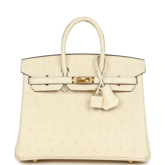 Nata ostrich handbag with top handles, front flap, gold-tone lock, and hanging key clochette.