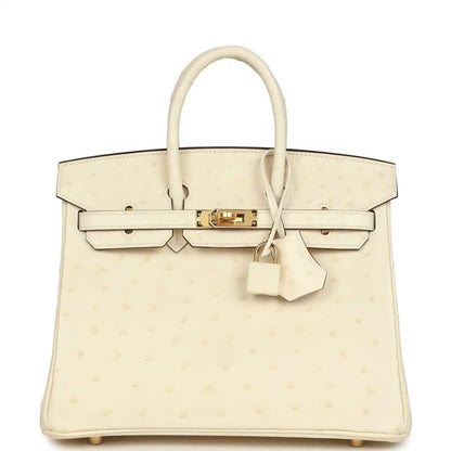 Nata ostrich handbag with top handles, front flap, gold-tone lock, and hanging key clochette.