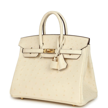 Nata ostrich handbag with top handles, front flap, gold-tone clasp and belt details.
