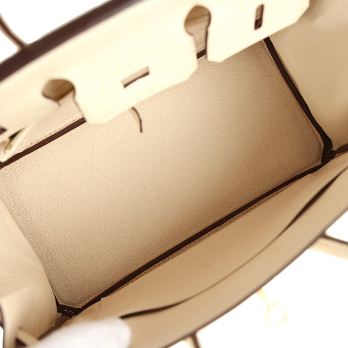 Nata ostrich handbag interior lining with partial zipper track and stitched seams.