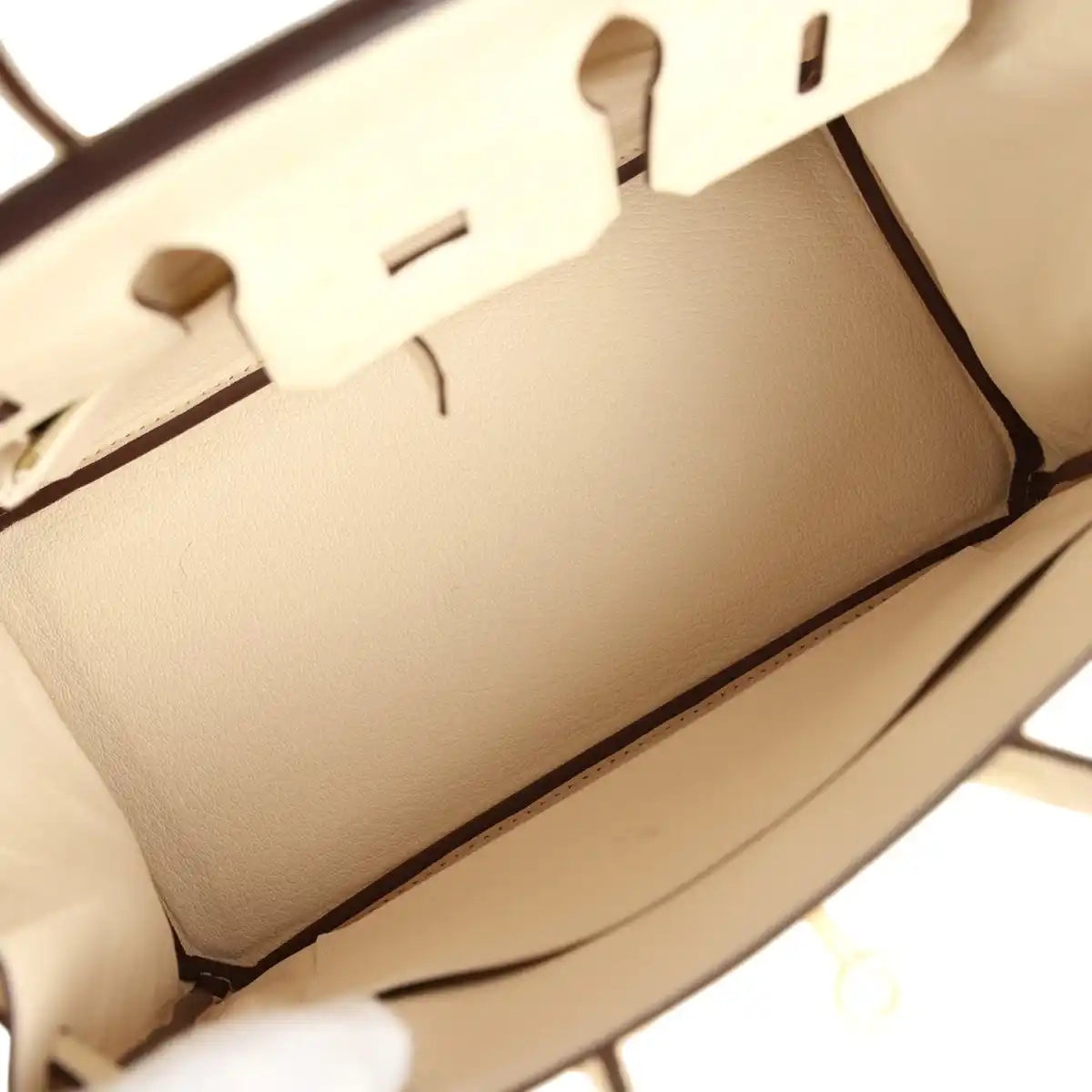 Nata ostrich handbag interior lining with partial zipper track and stitched seams.