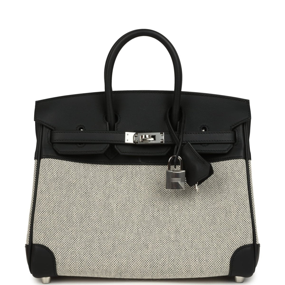 Black and cream canvas Hermes Birkin 25 handbag with top handles and front clasp.