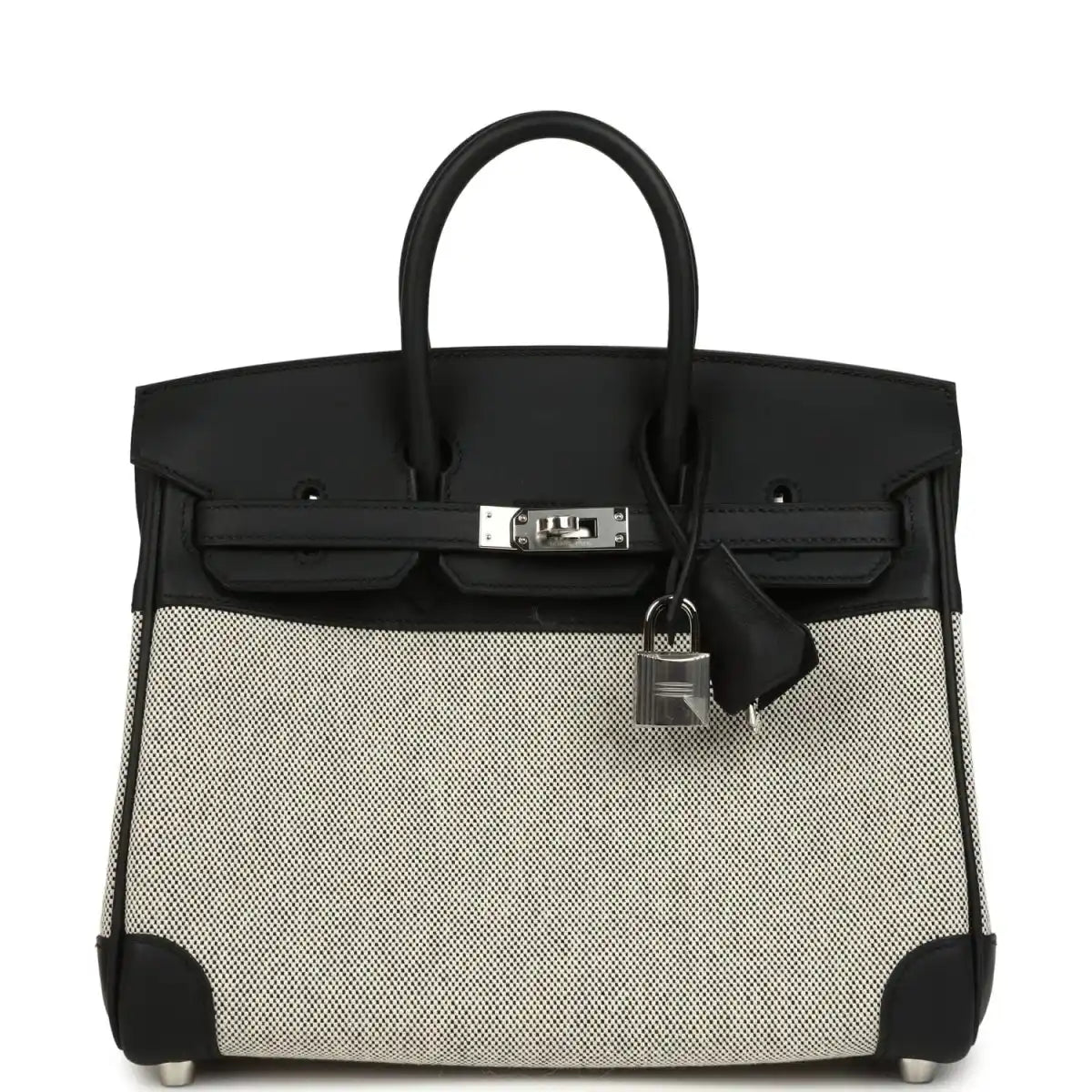 Black and cream canvas Hermes Birkin 25 handbag with top handles and front clasp.