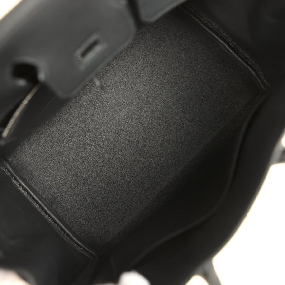 Black leather Hermes Birkin 25 handbag interior with smooth lining and stitched seams.