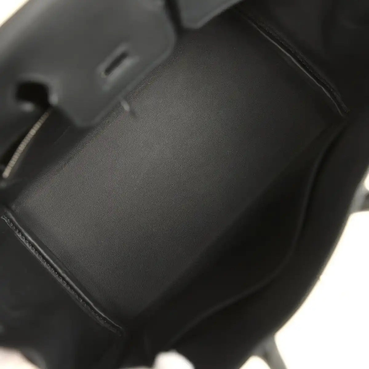 Black leather Hermes Birkin 25 handbag interior with smooth lining and stitched seams.