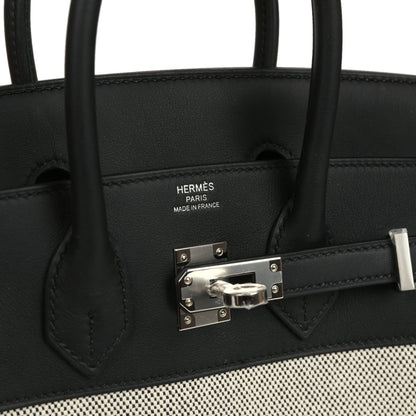 Black leather Hermes Birkin 25 handbag with Hermes stamp and metal front clasp.