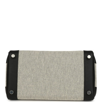 Cream canvas and black leather Hermes toiletry pouch with snap ends and eyelets.
