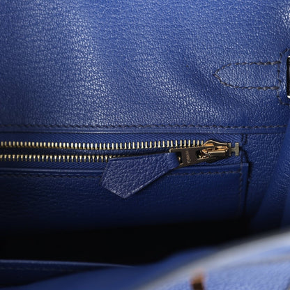 Hermes Birkin 25 handbag close-up: blue leather zipper with gold pull and stitching