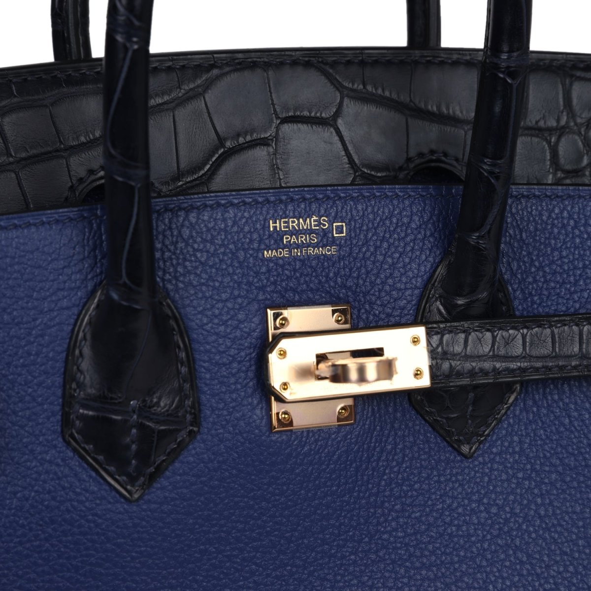 Hermes Birkin 25 handbag close-up: blue body, black alligator trim, gold front clasp