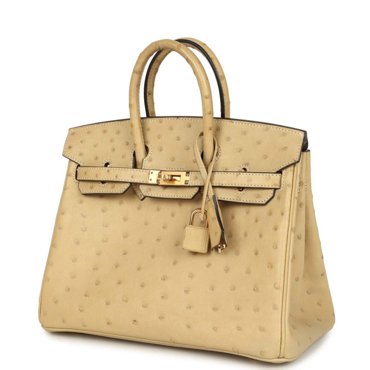 Tan ostrich leather handbag with top handles, front lock and flap closure, and hanging key.