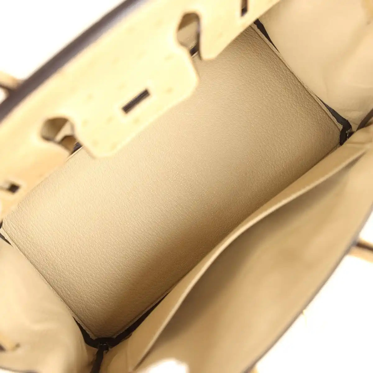 Tan interior view of ostrich leather handbag showing lining pocket and smooth leather panel.