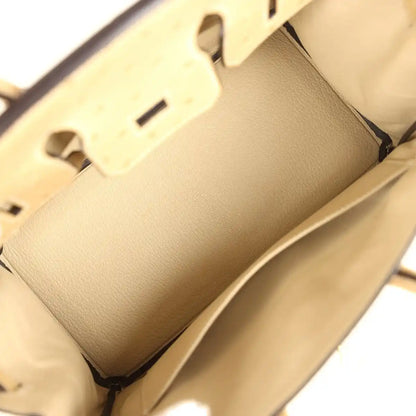 Tan interior view of ostrich leather handbag showing lining pocket and smooth leather panel.