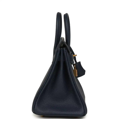Blue Togo leather handbag profile with two top handles and gold padlock charm