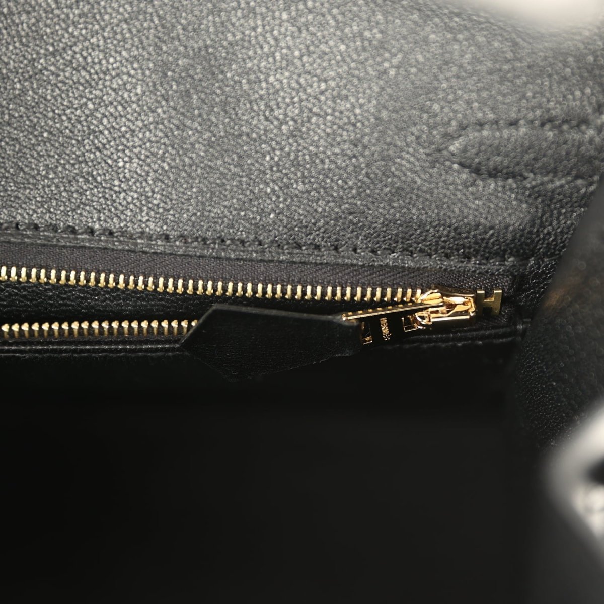 Black leather Birkin handbag with gold-tone zipper and pull tab