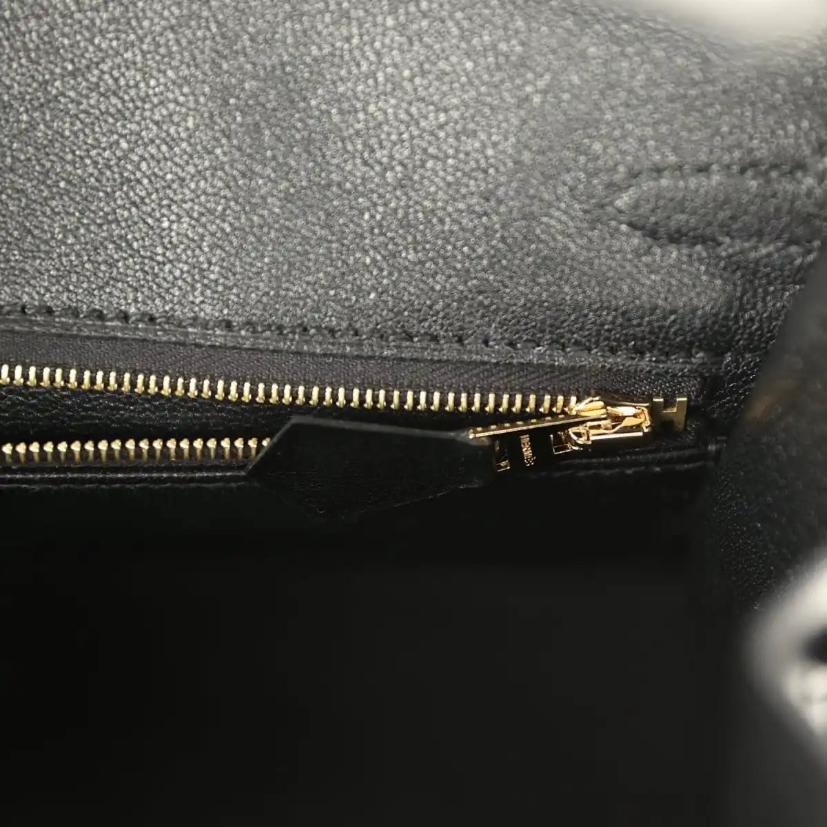 Black leather Birkin handbag with gold-tone zipper and pull tab