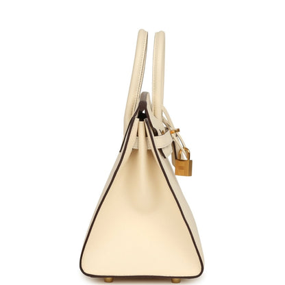 Hermes Birkin Sellier 25 handbag side view with cream leather, straps, and gold hardware lock
