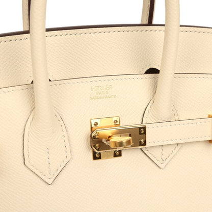Hermes Birkin Sellier 25 handbag close-up of gold lock plate and cream leather stitching