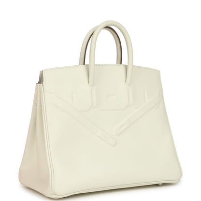Cream leather handbag with embossed pattern and top handles, angled side view.