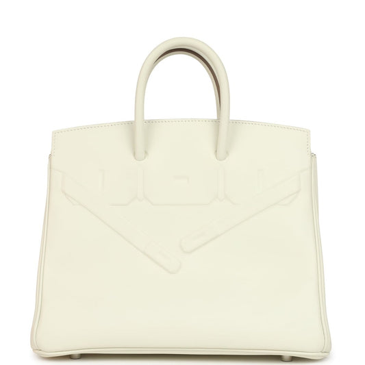 Cream leather structured handbag with embossed detailing and two top handles.