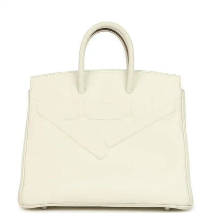 Cream leather structured handbag with embossed detailing and two top handles.