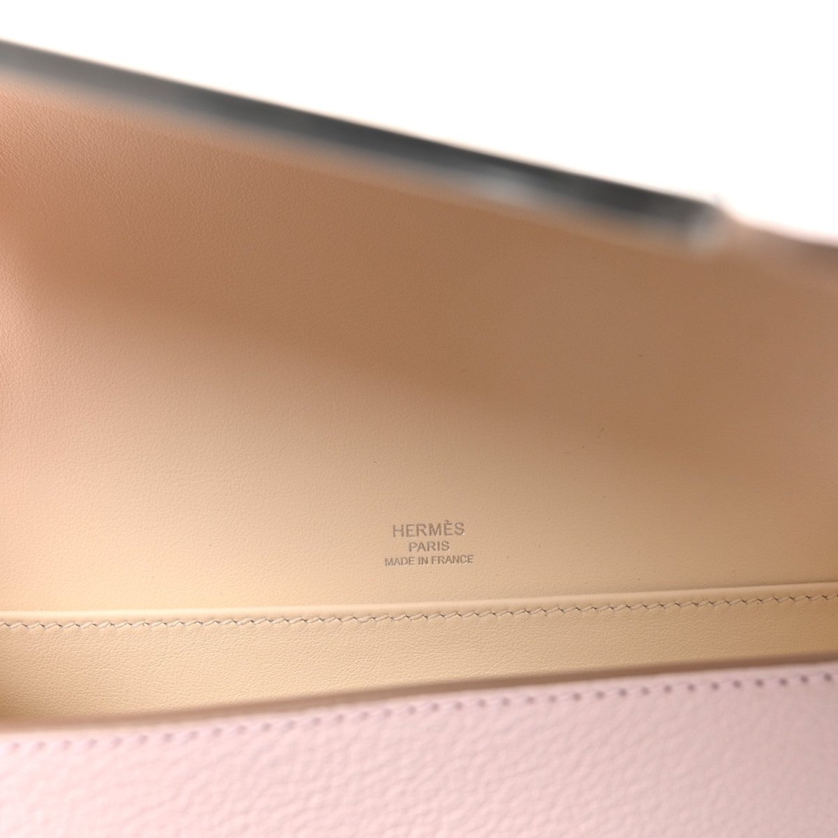 Hermès Geta messenger bag interior with embossed branding on light beige leather
