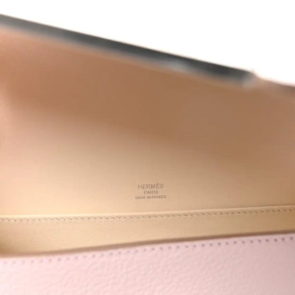 Hermès Geta messenger bag interior with embossed branding on light beige leather