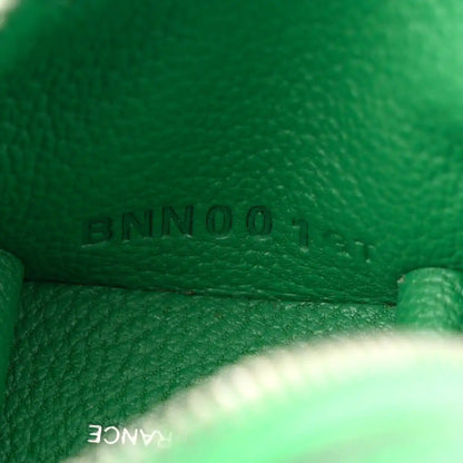 Green leather close-up with 'BAMBOO' stamped on bag charm interior seam