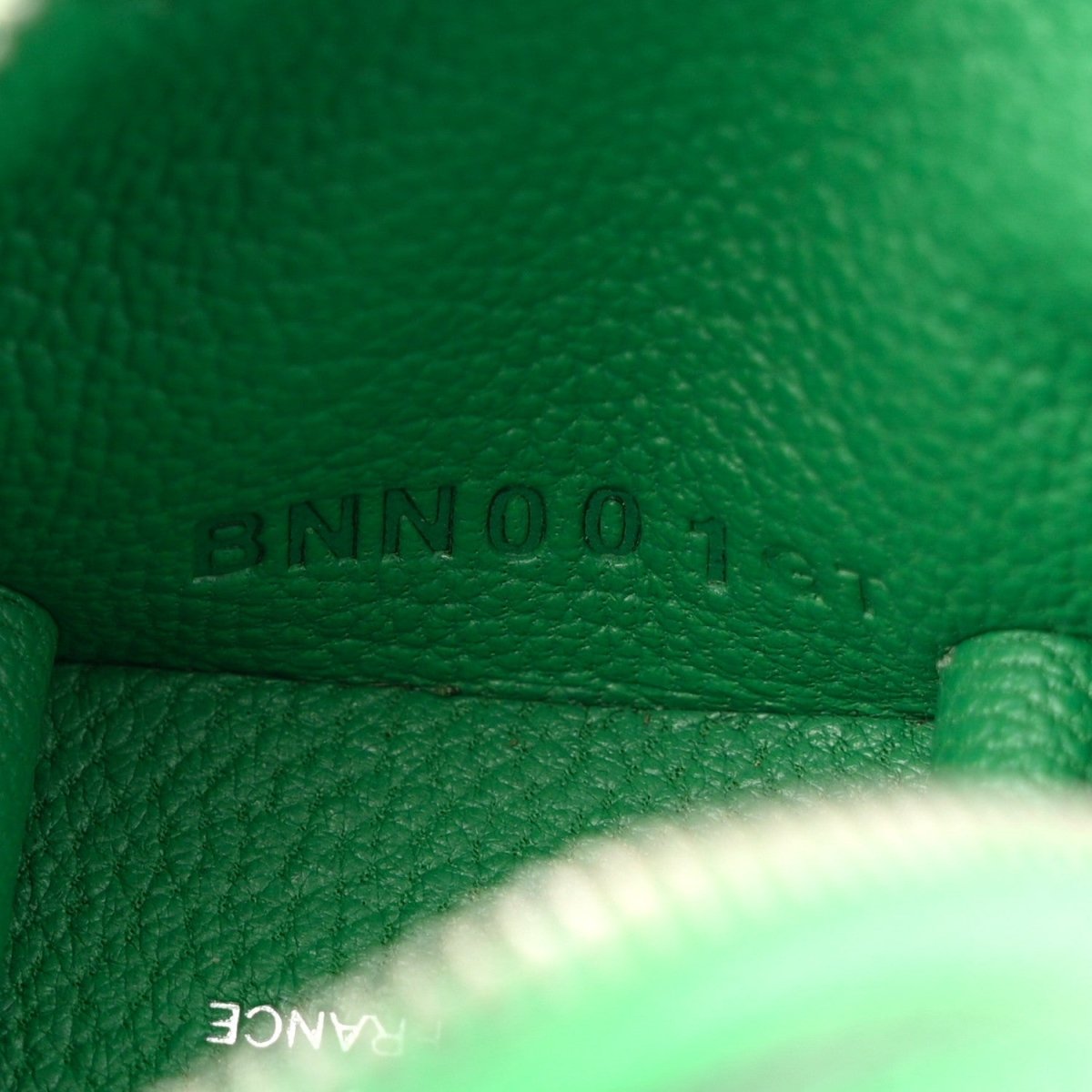 Green leather close-up with 'BAMBOO' stamped on bag charm interior