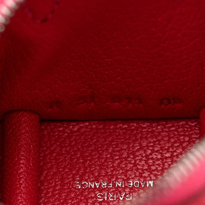 Red leather bag charm close-up with embossed "MADE IN FRANCE" text