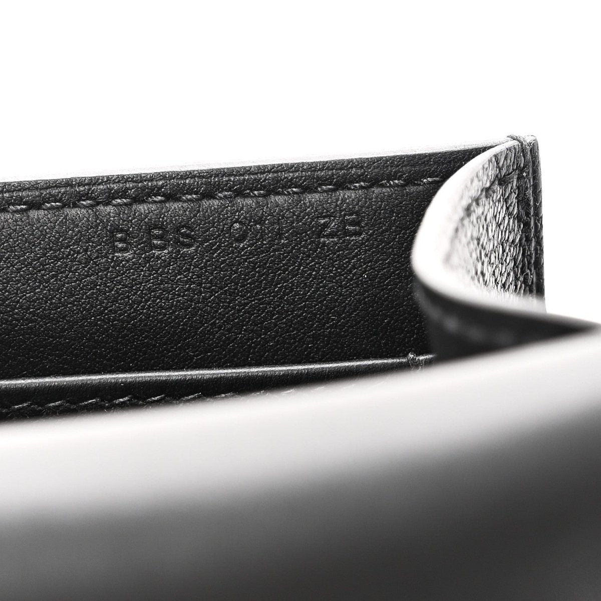 Hermes black leather crossbody bag edge with engraved lettering