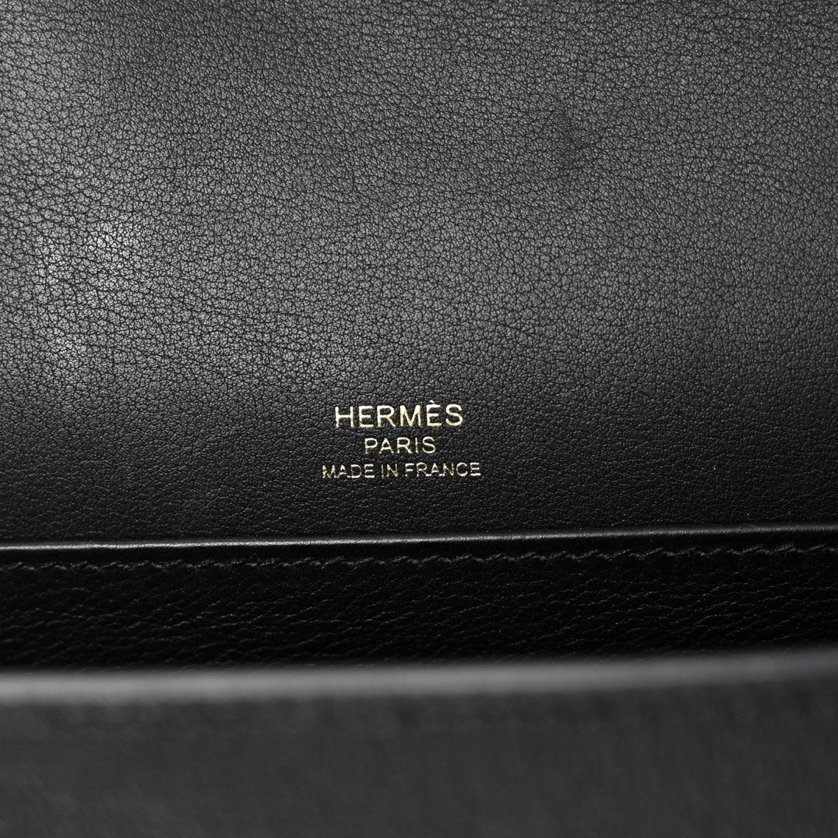 Hermes black leather crossbody bag with 'Hermès Paris Made in France' stamp