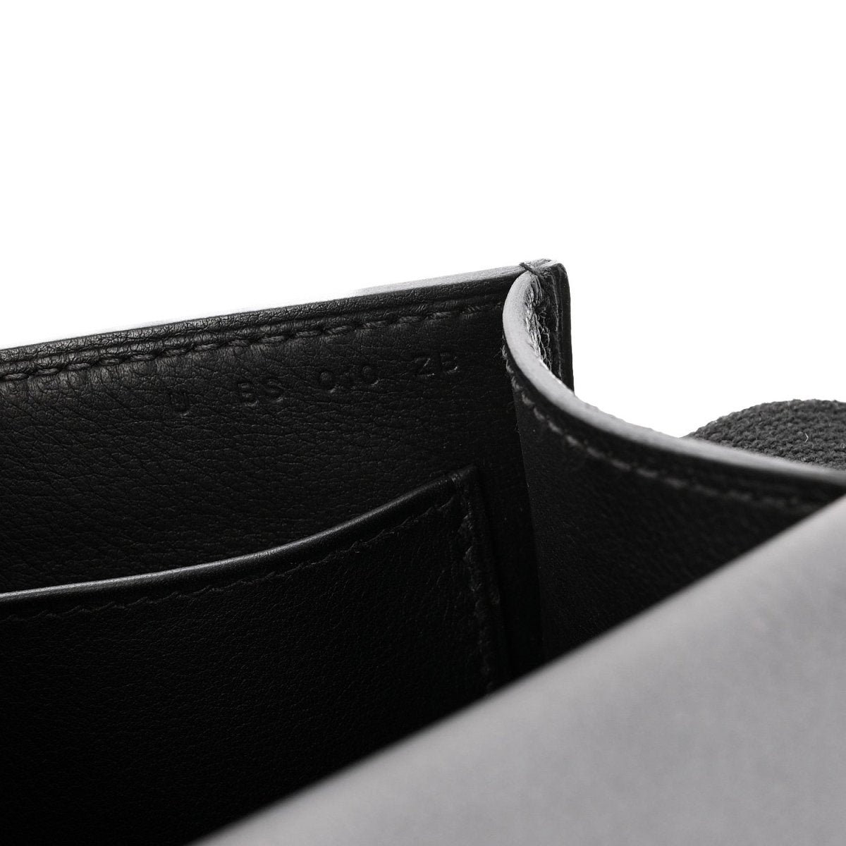 Black leather crossbody bag corner and interior seam detail