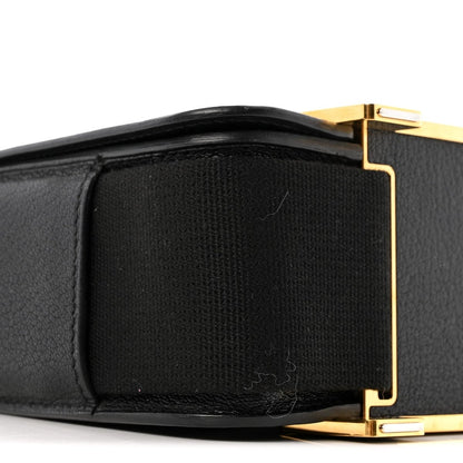 Black leather crossbody bag front flap with gold-tone clasp