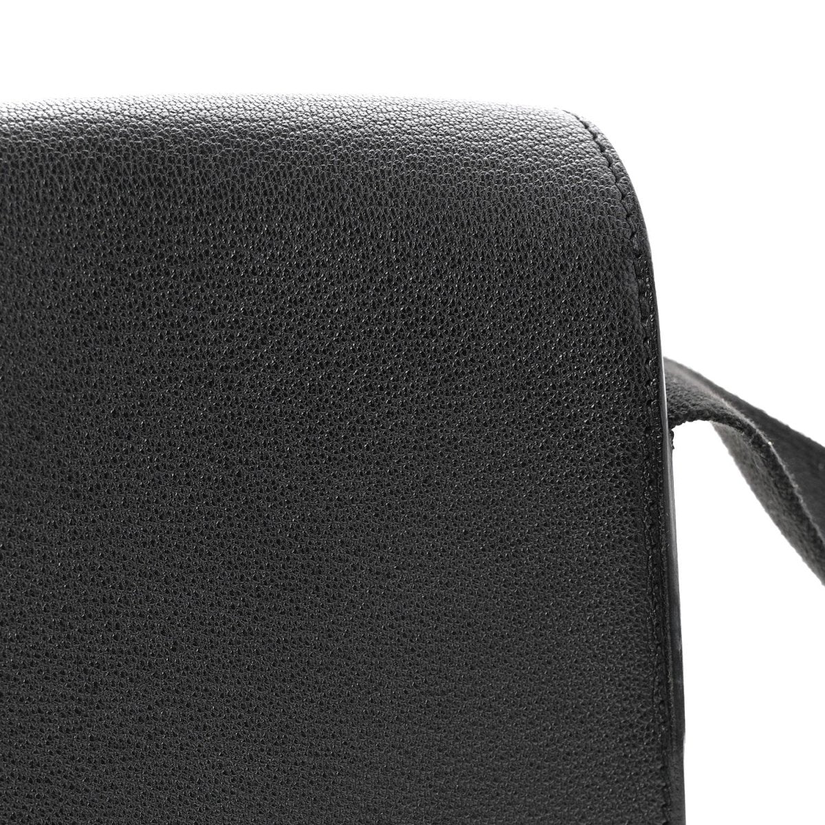 Black leather crossbody bag side panel with smooth rounded edge