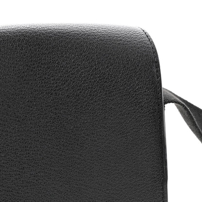 Black leather crossbody bag side panel with smooth rounded edge