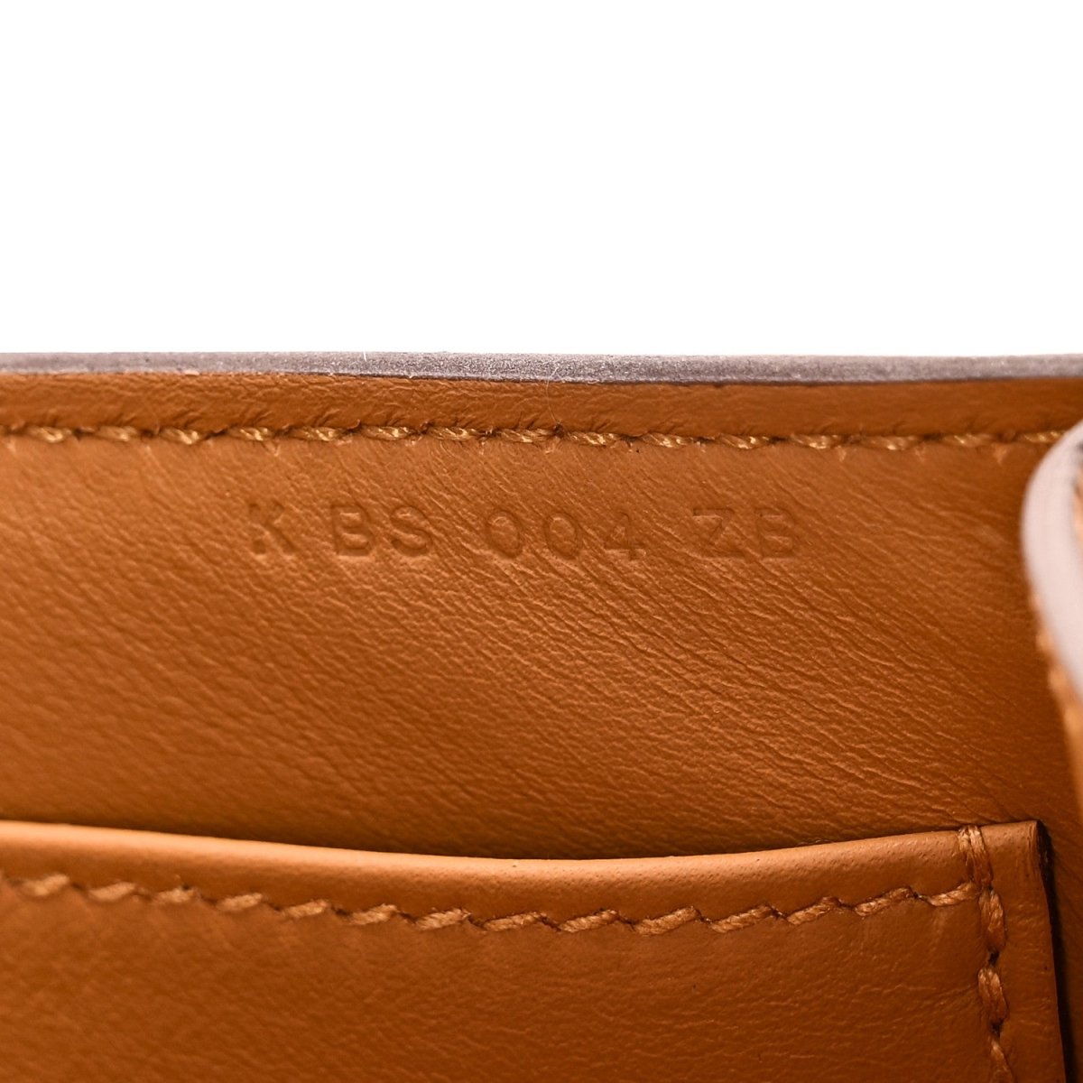 Caramel leather bag interior with stitched edge and small embossed date/code mark