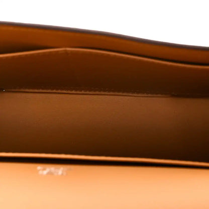 Caramel leather bag interior panel with embossed branding and top edge stitching detail