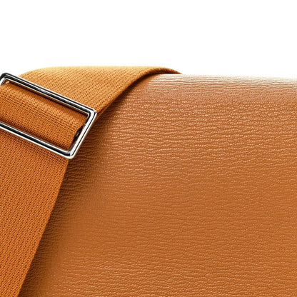 Caramel leather flap and adjustable webbing strap with silver-tone buckle hardware