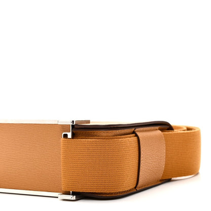 Caramel leather messenger bag with structured body, silver-tone buckle, and webbing strap