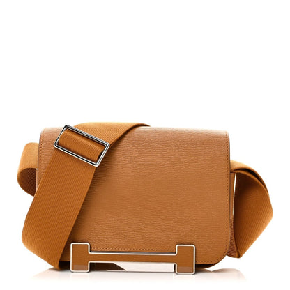 Caramel leather messenger bag with adjustable fabric shoulder strap and metal buckle closure