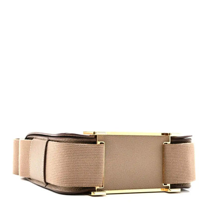 Taupe messenger bag with front flap, wide canvas strap, and gold-tone hardware