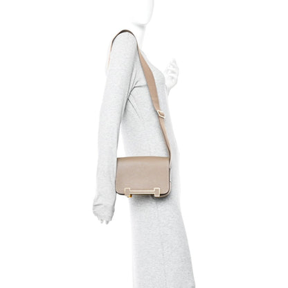 Taupe crossbody messenger bag with flap closure and gold-tone hardware on strap
