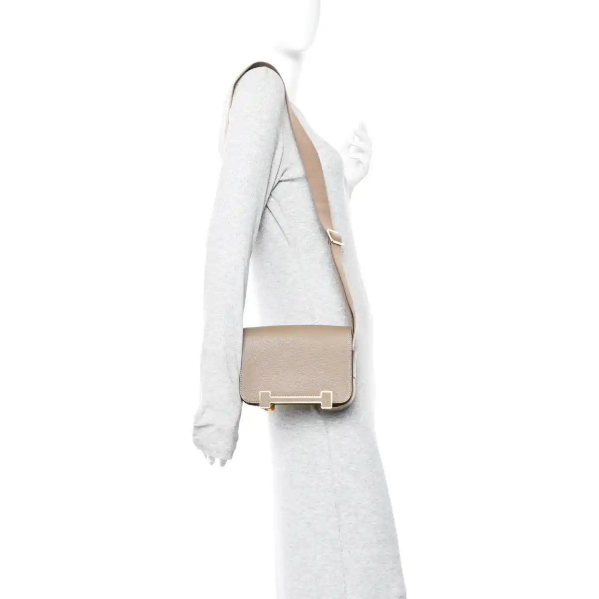 Taupe crossbody messenger bag with flap closure and gold-tone hardware on strap