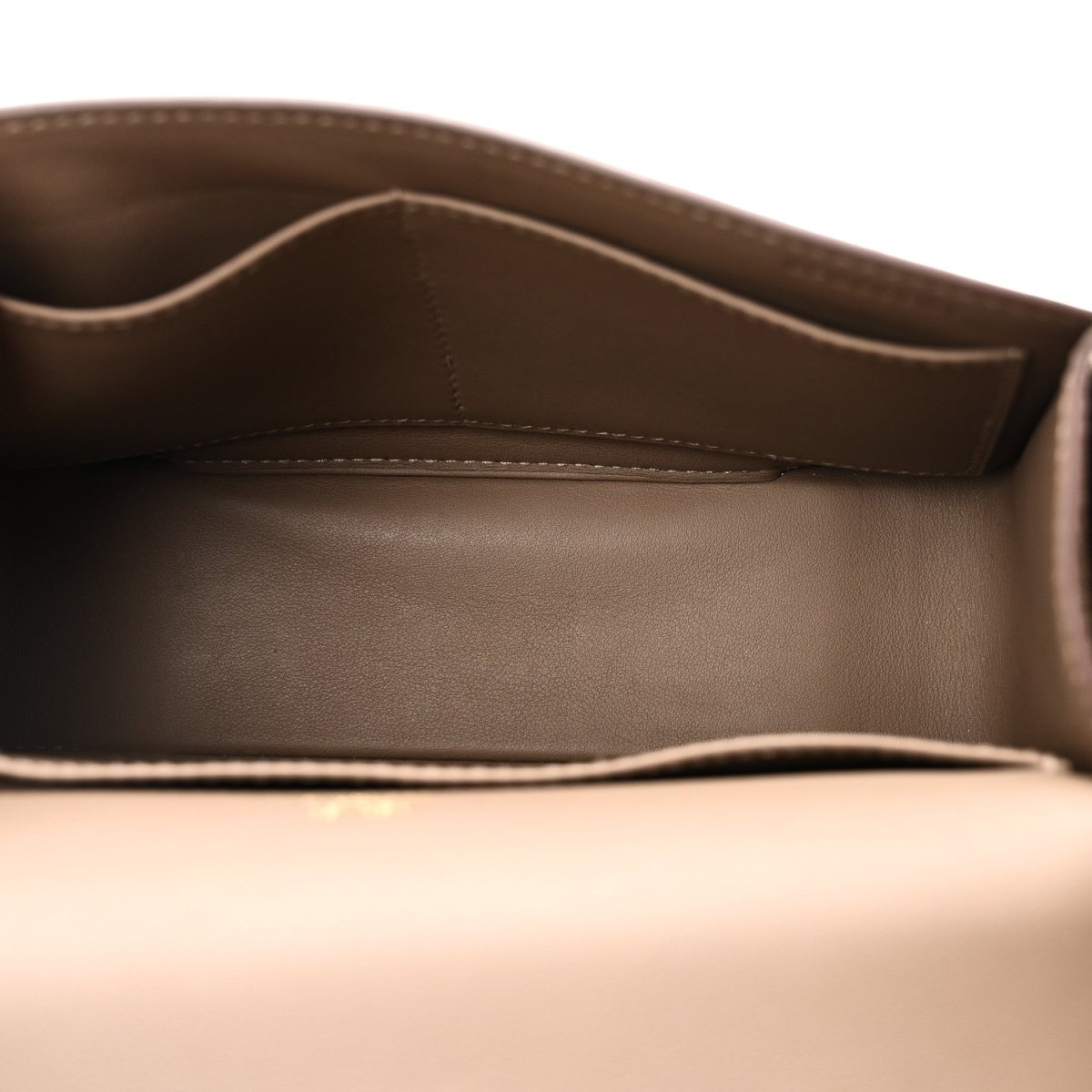 Interior view of taupe leather messenger bag with stitched trim and open top