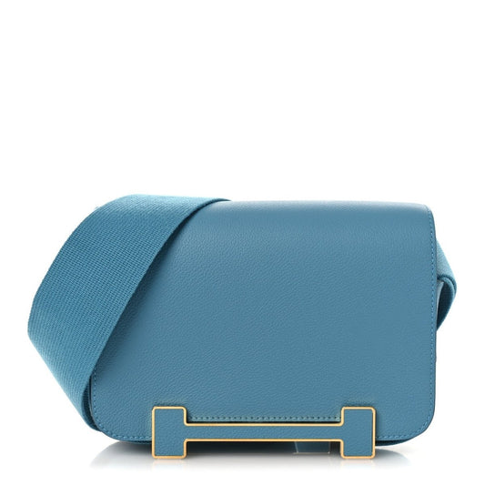 Blue leather messenger bag with flap, gold-tone clasp, and crossbody strap.