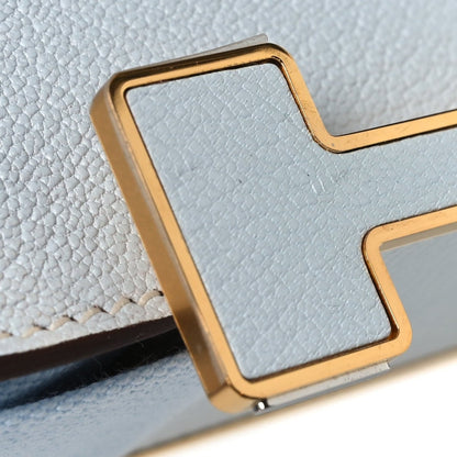 Leather crossbody bag with flap, gold-tone trim, textured light blue exterior corner