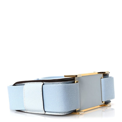 Light blue leather crossbody bag bottom corner with gold-tone hardware