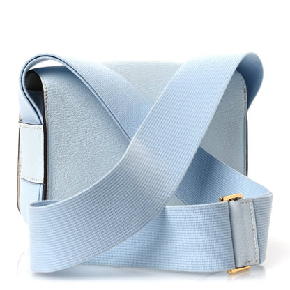 Light blue leather crossbody bag with wide strap and gold-tone clasp