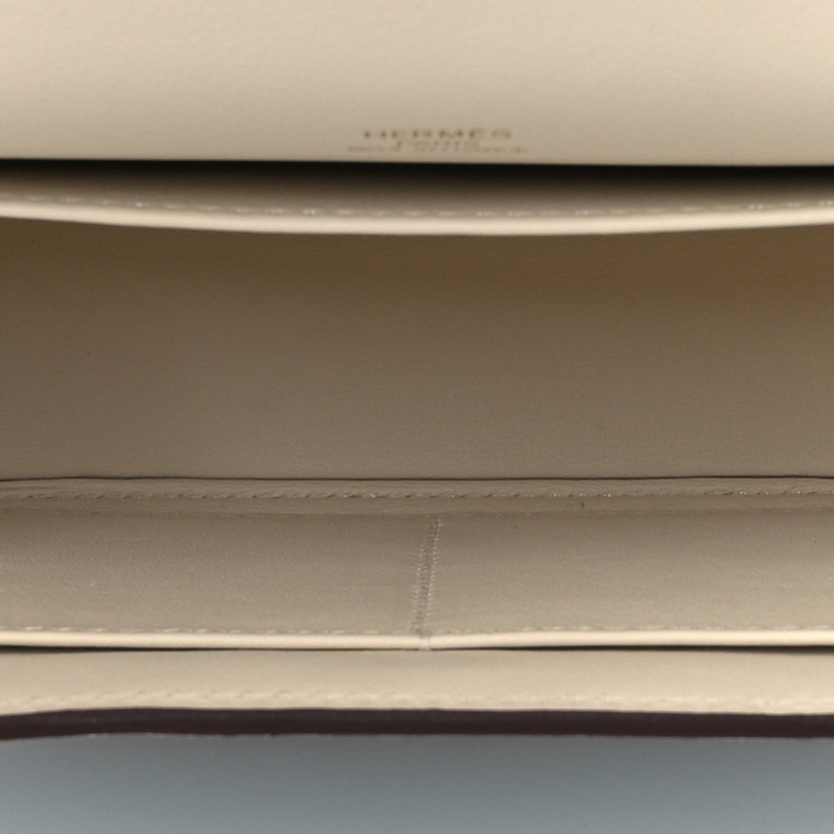Light leather crossbody lining seam and stitching detail